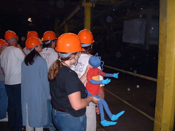 Image of Energy Ant and a group of teachers taking a tour of the plant.