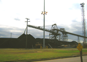 image of coal pouring off of a conveyer belt