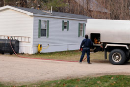 A photograph of heating oil being delivered to a home