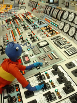 Image of Energy Ant at the power station control board.