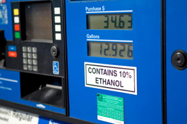 A photograph of a gasoline pump showing a plaque that says the gasoline contains 10% ethanol