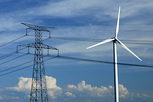 A photograph of a wind turbine and power lines.