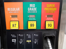 A gasoline pump showing different grades of gasoline