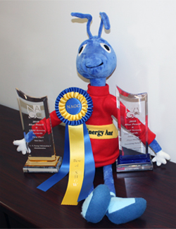 Picture of Energy Ant with awards from the National Association of Government Communicators.